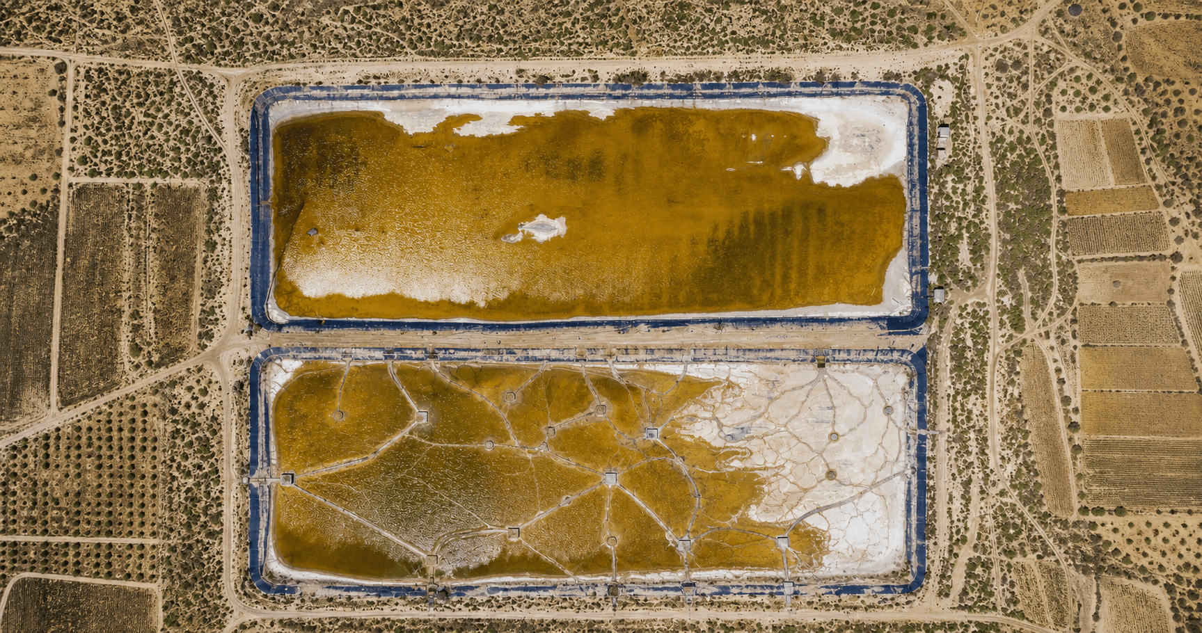 Two aerial ochre basins, one plain and one reorganized by a network of paths and service points